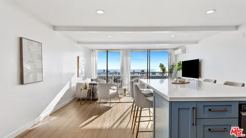 a bathroom with a granite countertop sink a mirror and shower