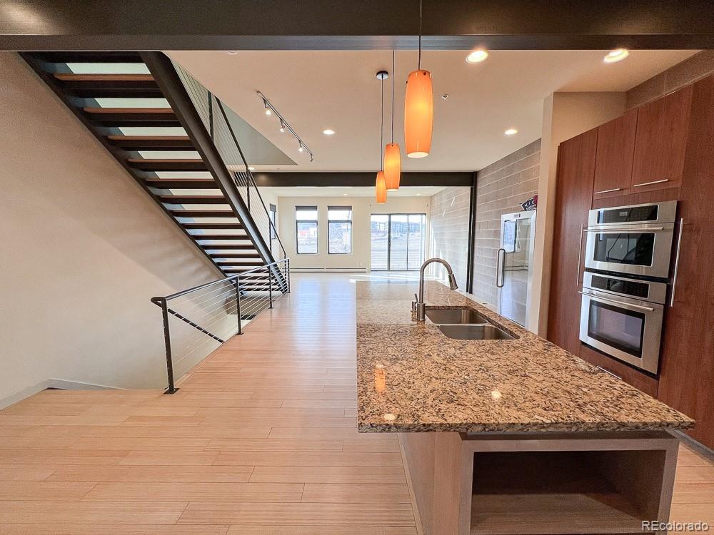 11570 Colony Row Broomfield, CO 80021 - Photo 11 of 24 a kitchen with stainless steel appliances granite countertop a stove and a sink
