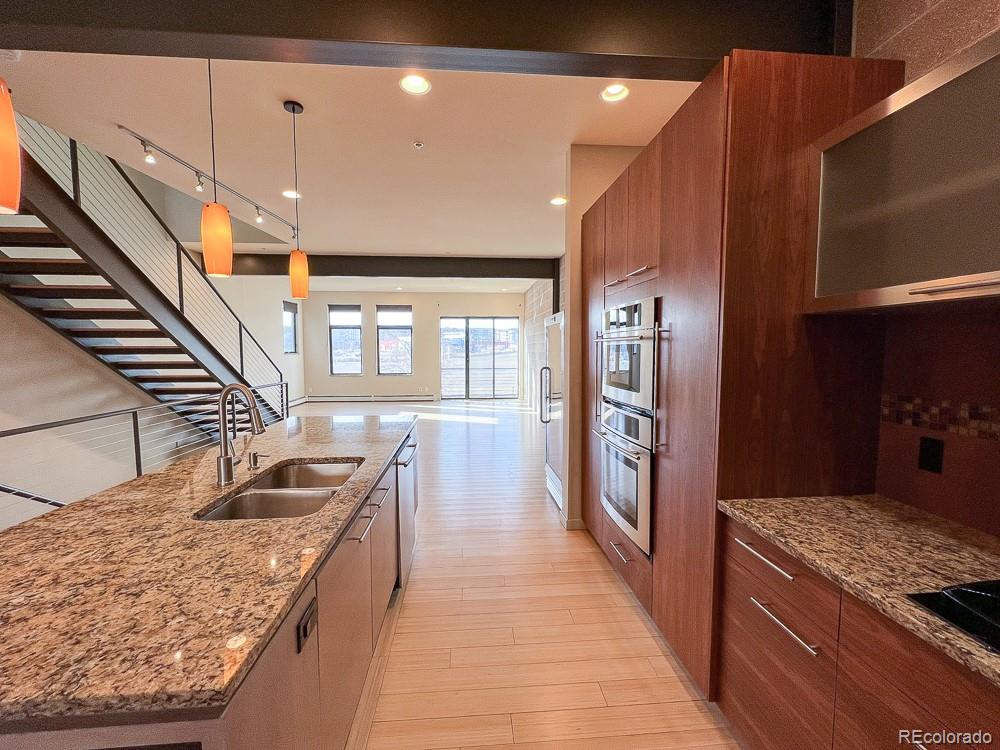 11570 Colony Row Broomfield, CO 80021 - Photo 12 of 24 a kitchen with stainless steel appliances granite countertop a refrigerator a stove and a sink