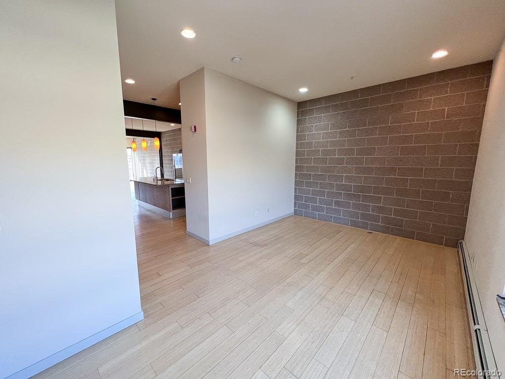 11570 Colony Row Broomfield, CO 80021 - Photo 15 of 24 a view of hallway with stairs and wooden floor