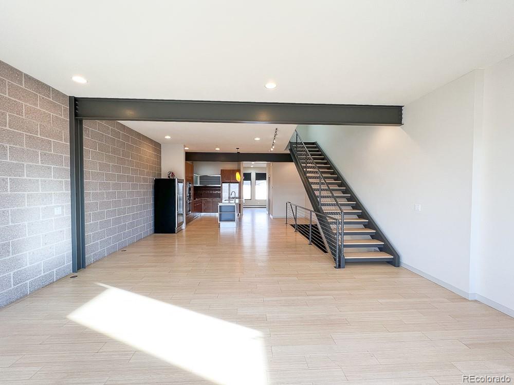 11570 Colony Row Broomfield, CO 80021 - Photo 18 of 24 a view of an empty room with wooden floor