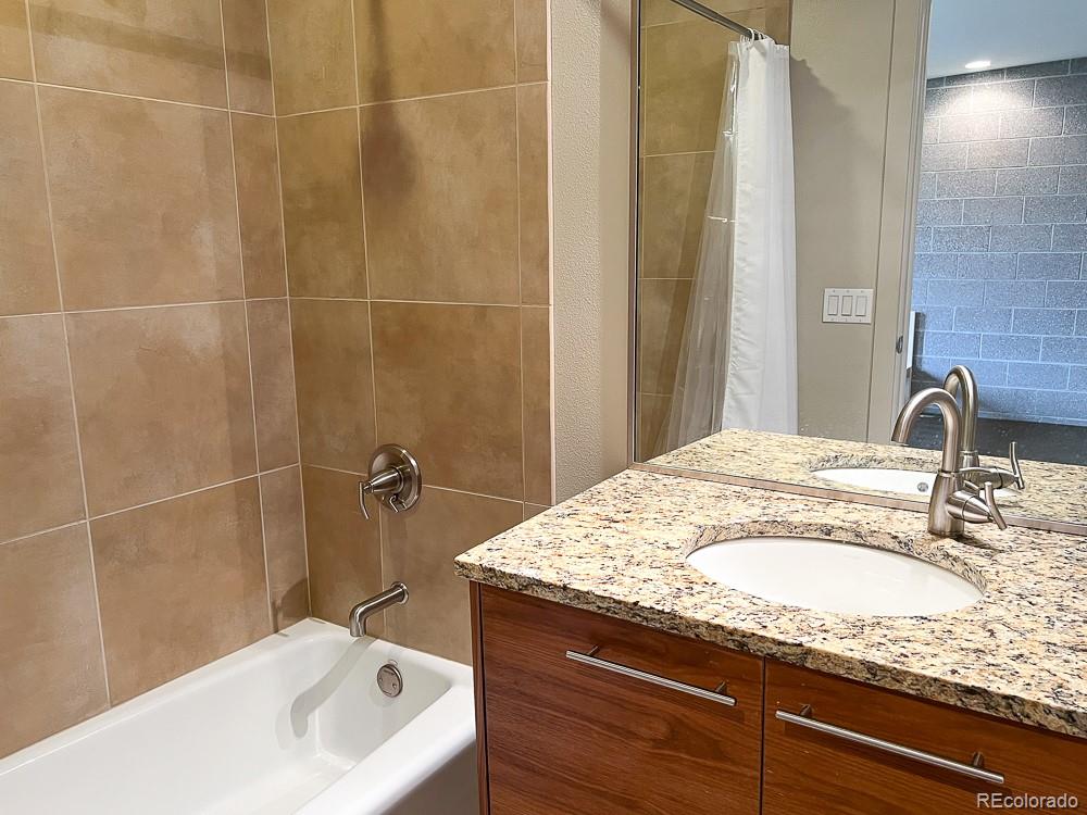 11570 Colony Row Broomfield, CO 80021 - Photo 22 of 24 a bathroom with a granite countertop sink and mirror