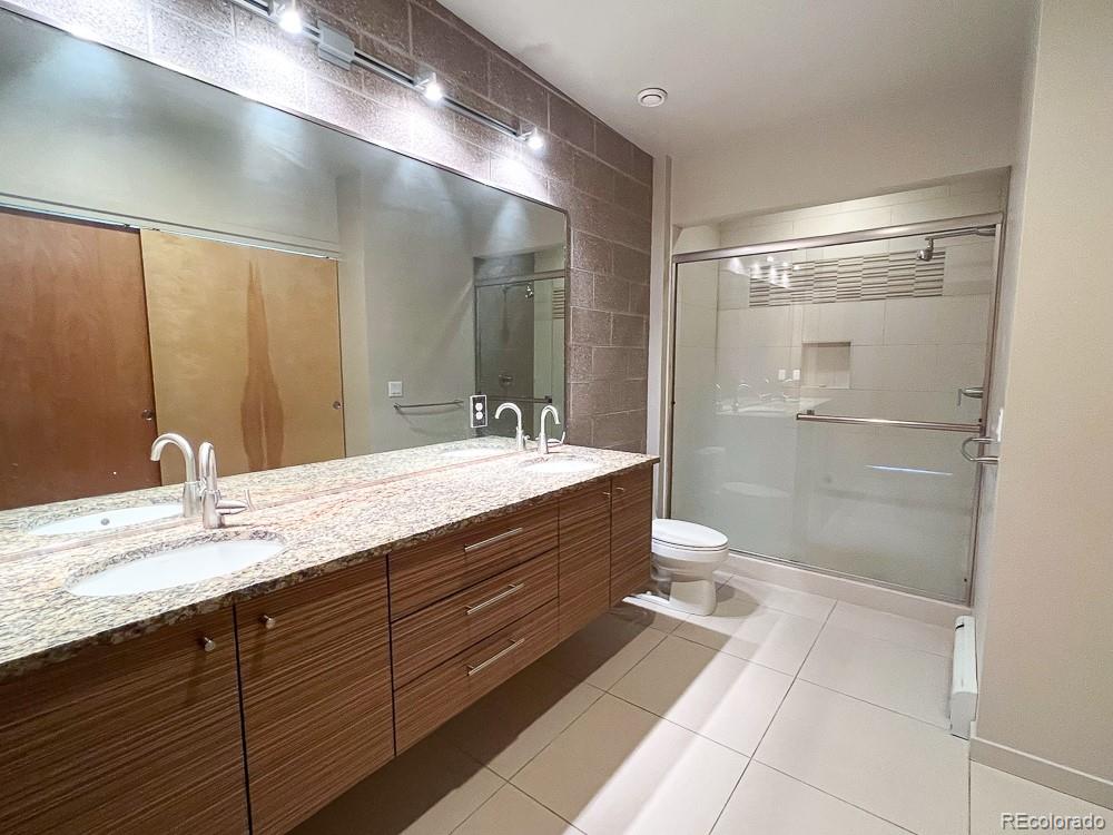 11570 Colony Row Broomfield, CO 80021 - Photo 24 of 24 a bathroom with a double vanity sink toilet and shower