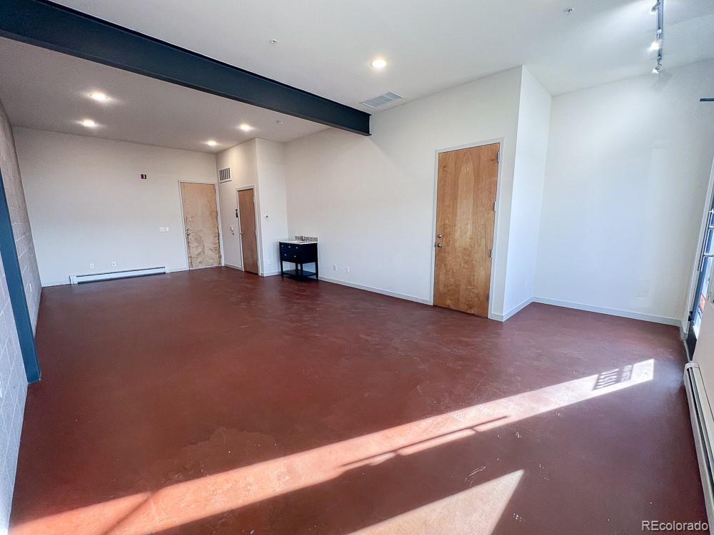 11570 Colony Row Broomfield, CO 80021 - Photo 4 of 24 a view of an empty room with wooden floor