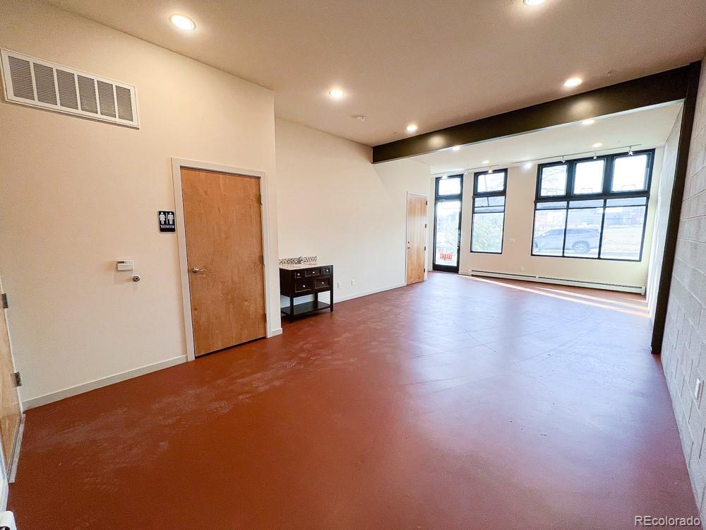 11570 Colony Row Broomfield, CO 80021 - Photo 5 of 24 a view of an empty room with a window and wooden floor
