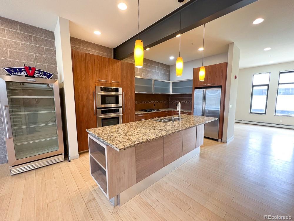 11570 Colony Row Broomfield, CO 80021 - Photo 9 of 24 a kitchen with stainless steel appliances granite countertop a stove and a refrigerator