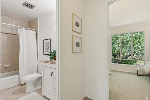 a white toilet sitting next to a bathroom sink
