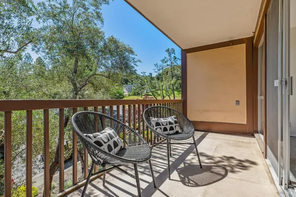 a view of a balcony with furniture