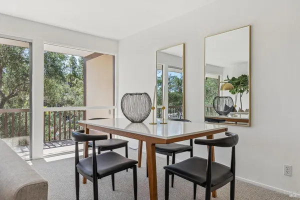 a view of a dining room with furniture window and outside view