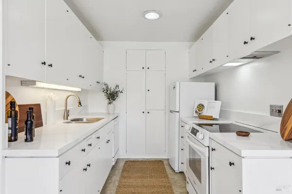 a kitchen with granite countertop a sink and cabinets
