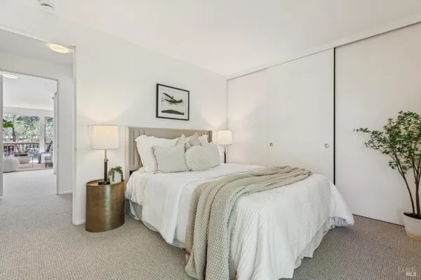 a bedroom with bed and a potted plant