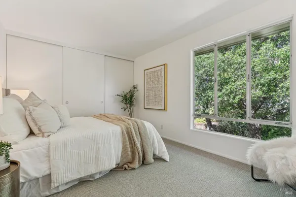 a bedroom with a bed and a window