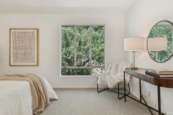 a bedroom with a bed a lamp and a window