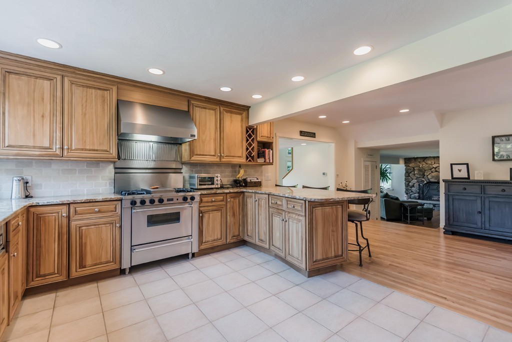 351 Main Street Boxford, MA 01921 - Photo 4 of 30 a kitchen with stainless steel appliances granite countertop a stove a sink and a refrigerator