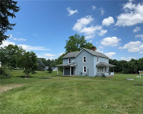 a view of house with outdoor space and garden