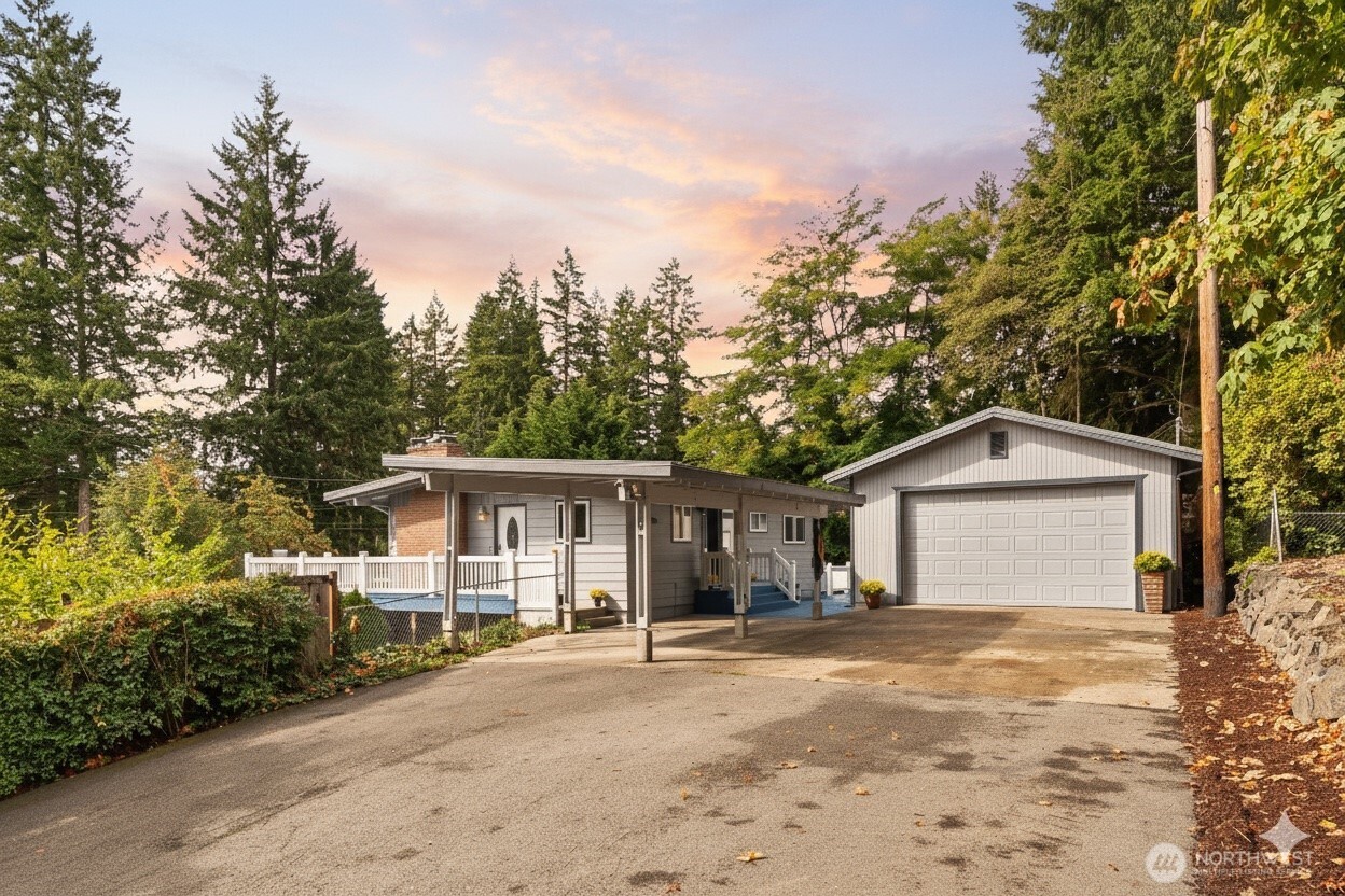18308 Southeast 145th Street Renton, WA 98059 - Photo 26 of 26 a front view of a house with a garden and trees