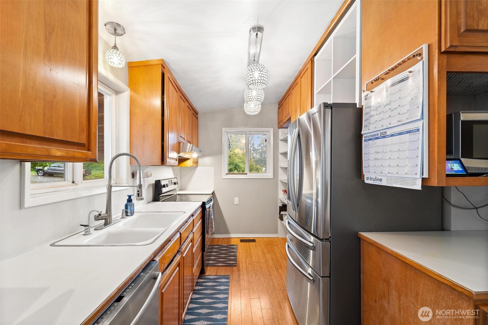 18308 Southeast 145th Street Renton, WA 98059 - Photo 6 of 26 a kitchen with stainless steel appliances a sink and a refrigerator
