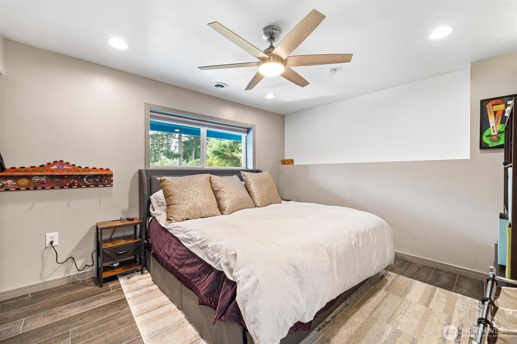 18308 Southeast 145th Street Renton, WA 98059 - Photo 7 of 26 a bedroom with a large bed and a chandelier