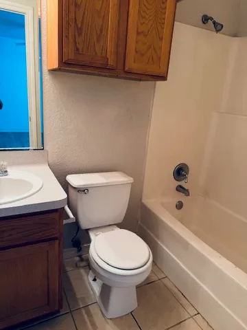 a view of a room with wooden floor and windows