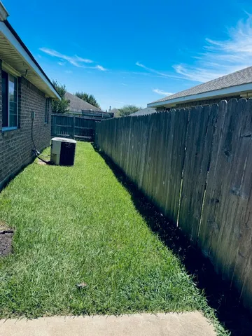 a backyard of a house with wooden floor and fence