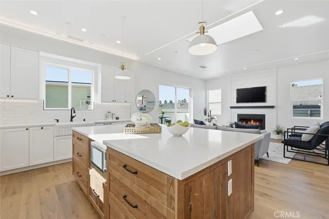 a large kitchen with kitchen island a sink appliances and cabinets