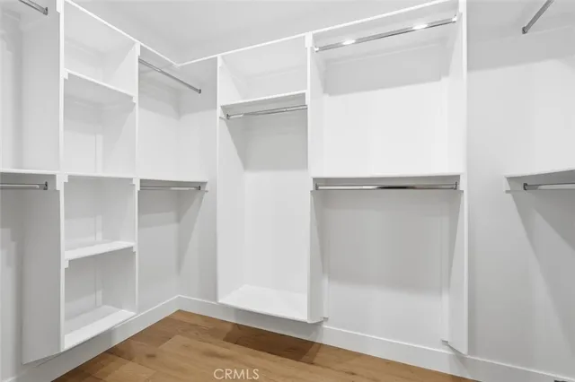 a view of walk in closet with empty racks