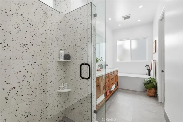 a bathroom with a granite countertop sink a toilet and shower