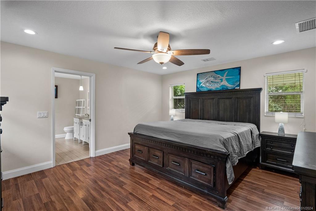 4911 Jorgensen Road Fort Pierce, FL 34981 - Photo 41 of 43 a bed sitting in a spacious bedroom next to a window