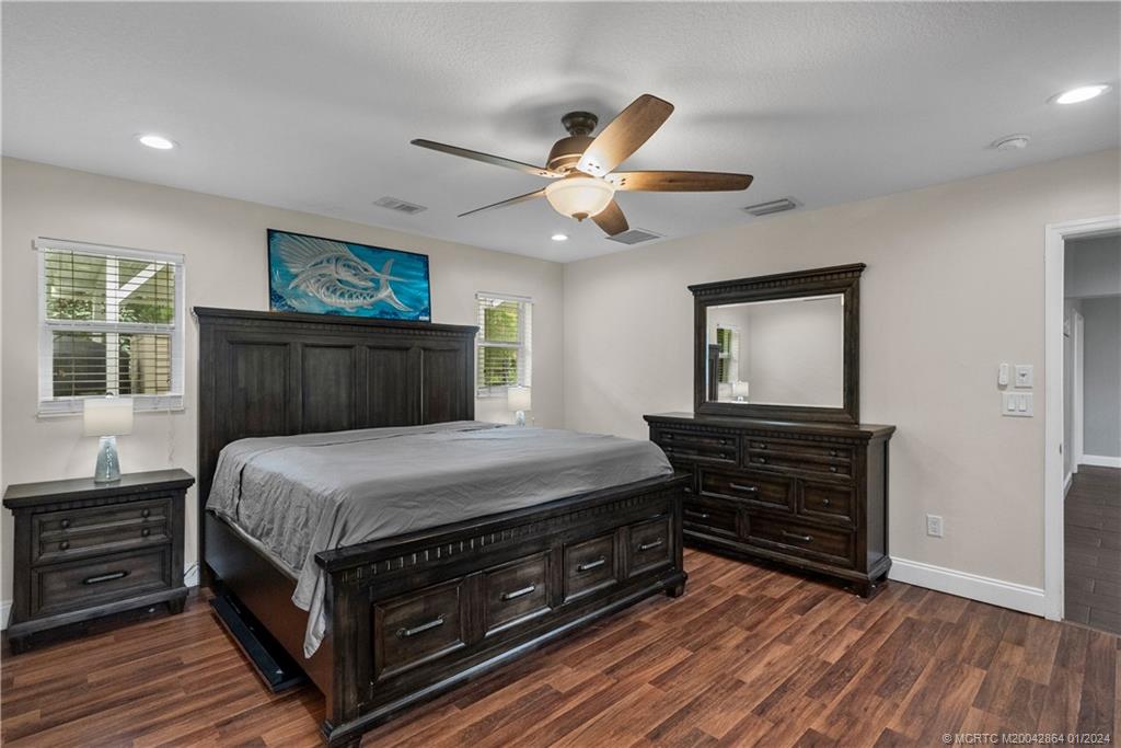 4911 Jorgensen Road Fort Pierce, FL 34981 - Photo 42 of 43 a bedroom with a bed and a dresser