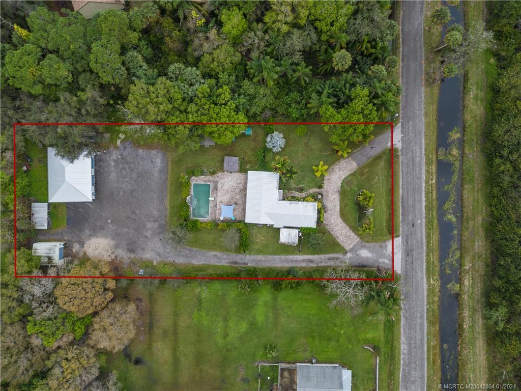 4911 Jorgensen Road Fort Pierce, FL 34981 - Photo 8 of 43 an aerial view of residential house with outdoor space