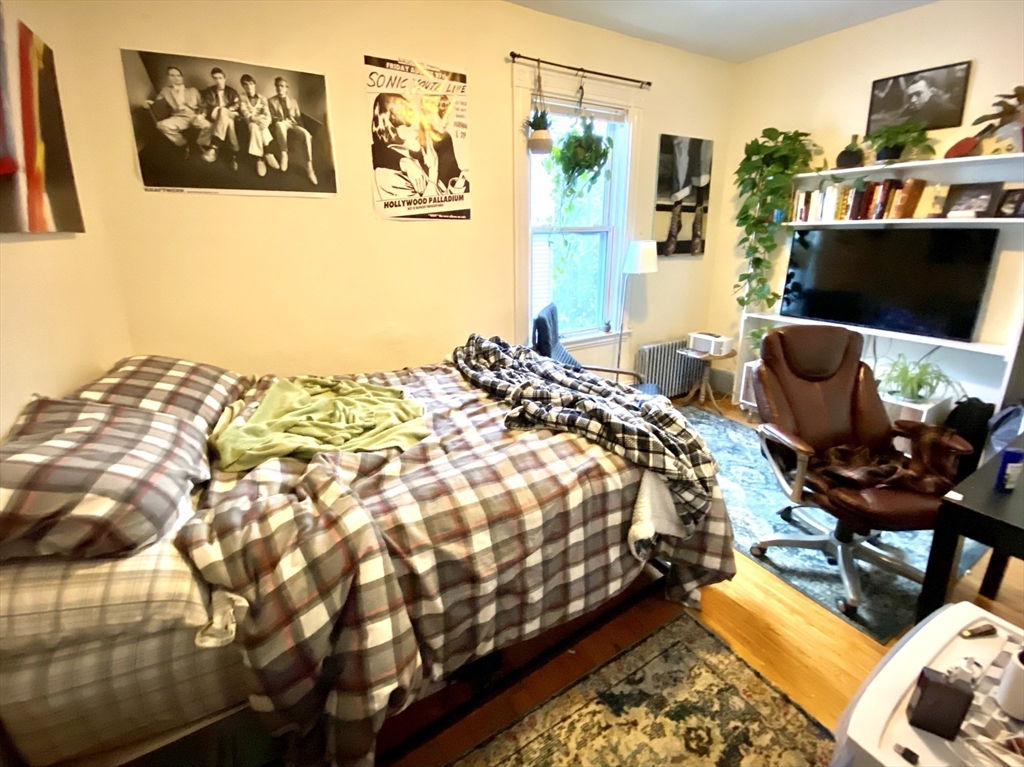 3 Oswald Street, Unit 3 Boston, MA 02120 - Photo 11 of 23 a bed sitting in a bedroom next to a window
