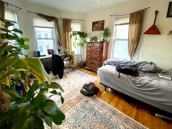 a living room with patio furniture and a potted plant