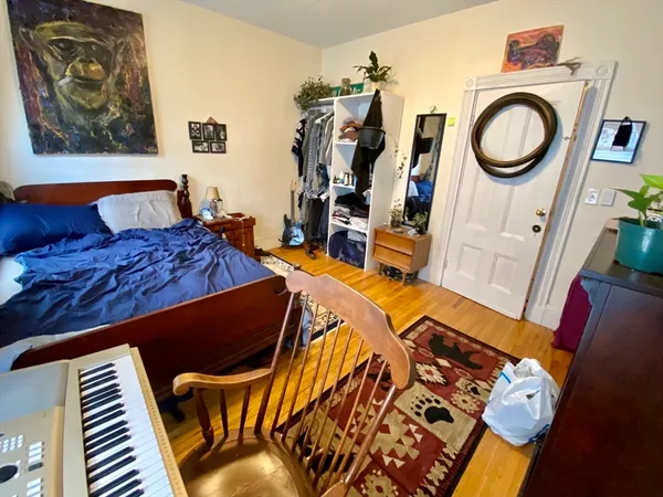 a bed sitting in a bedroom next to a small yard