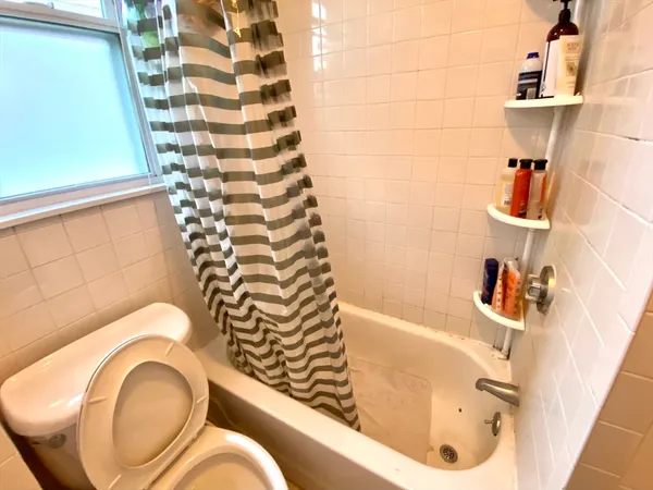 a bathroom with a bathtub and shower