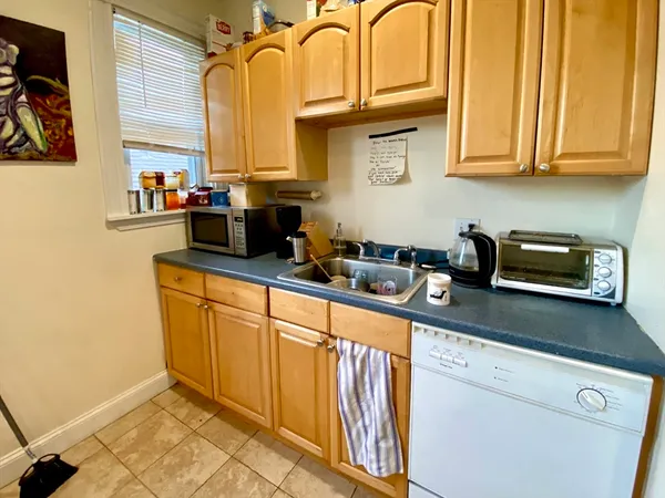 a kitchen with stainless steel appliances granite countertop a sink a stove and cabinets