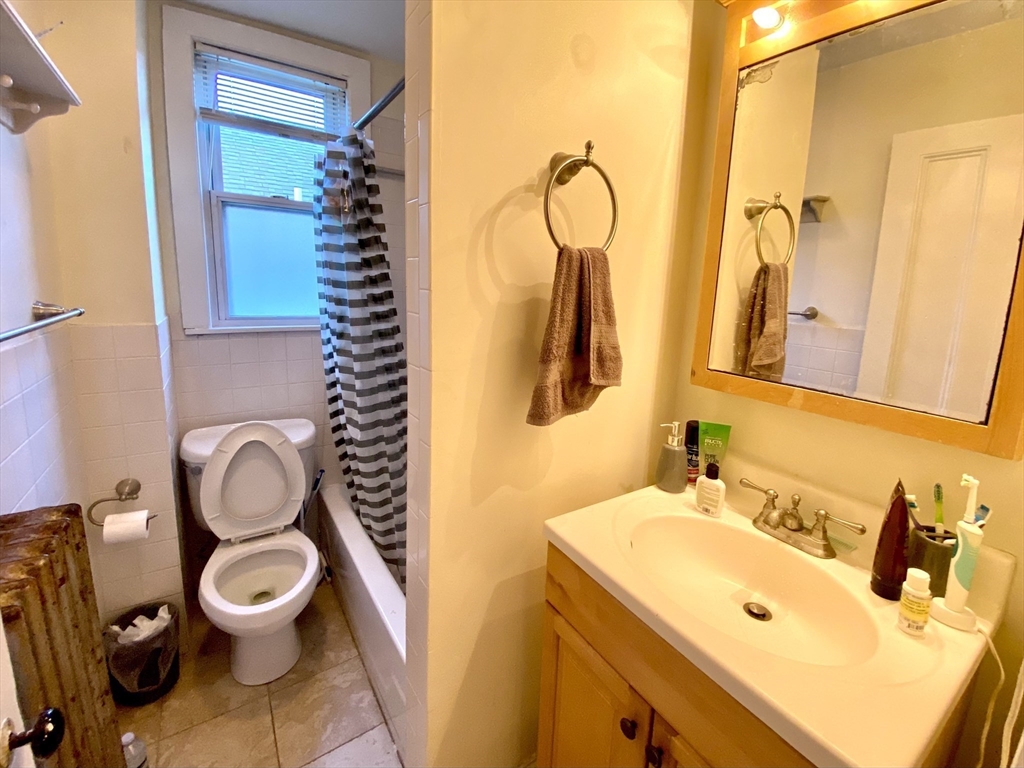 3 Oswald Street, Unit 3 Boston, MA 02120 - Photo 3 of 23 a bathroom with a toilet sink and mirror