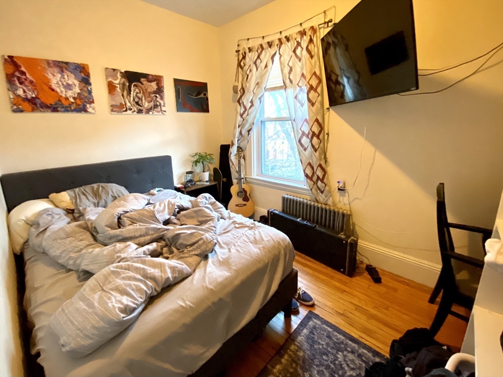 3 Oswald Street, Unit 3 Boston, MA 02120 - Photo 4 of 23 a bed sitting in a bedroom next to a window