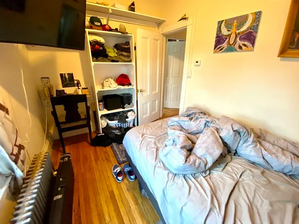 a bedroom with a bed and the view of bathroom