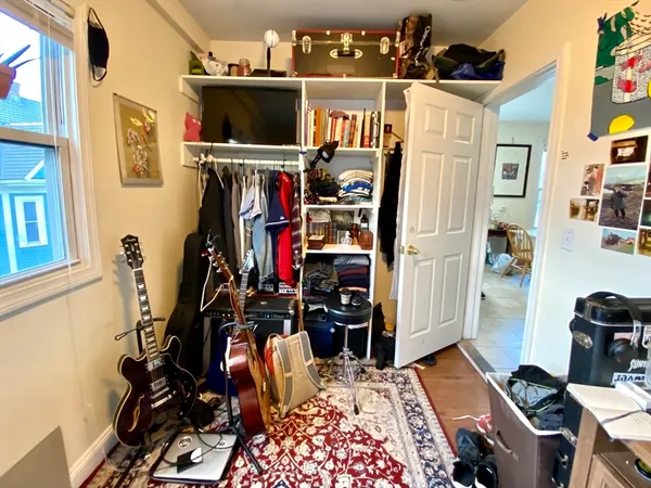 a view of a room with workspace and music instruments