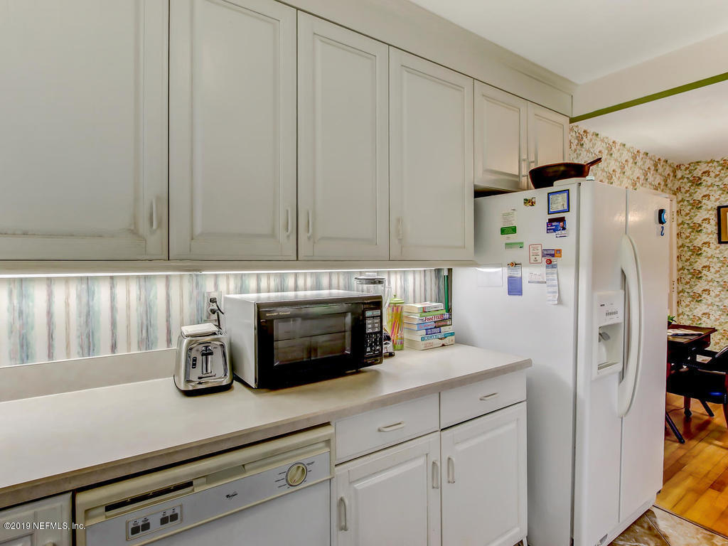 365 9th Street Atlantic Beach, FL 32233 - Photo 13 of 37 a kitchen with stainless steel appliances white cabinets and a refrigerator