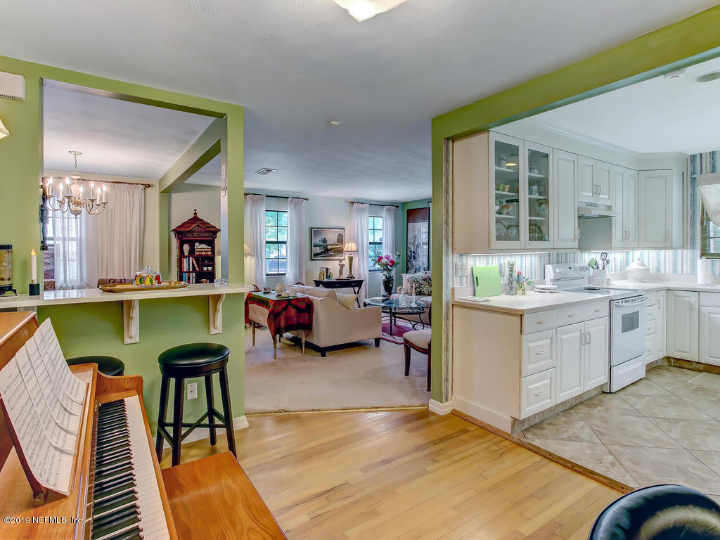365 9th Street Atlantic Beach, FL 32233 - Photo 17 of 37 a living room with kitchen island furniture and a kitchen view