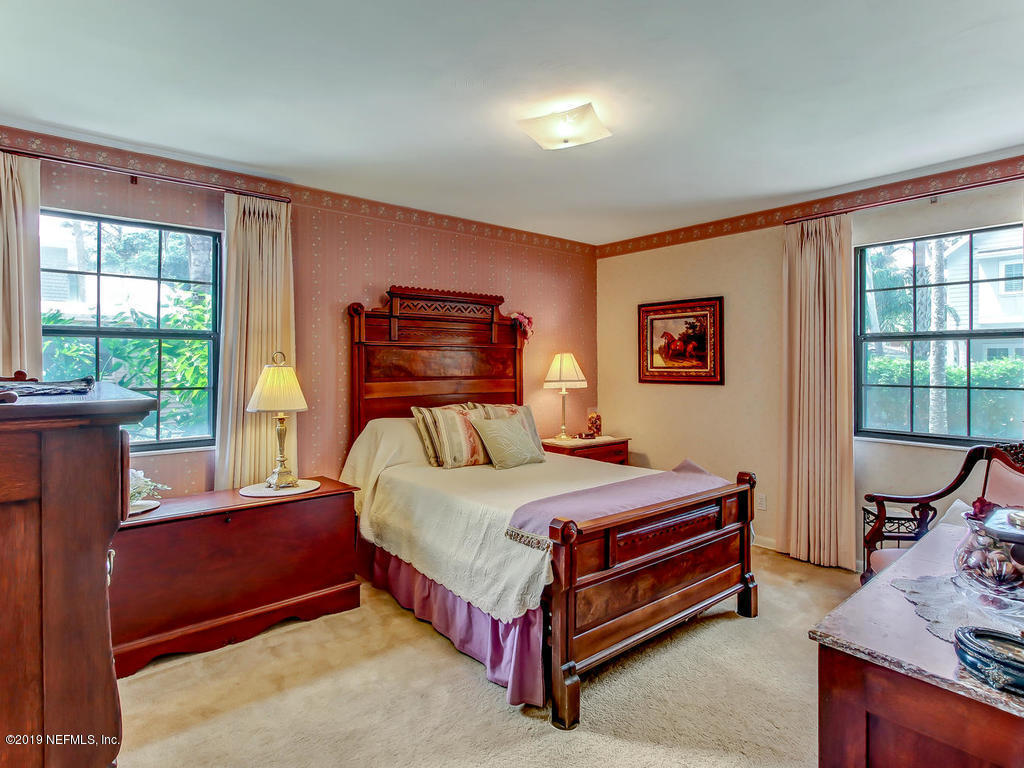 365 9th Street Atlantic Beach, FL 32233 - Photo 18 of 37 a bedroom with a bed and a window