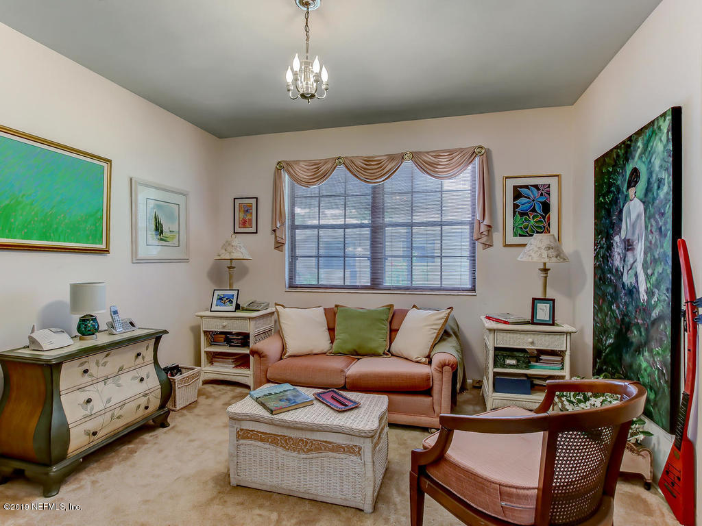 365 9th Street Atlantic Beach, FL 32233 - Photo 23 of 37 a living room with furniture a fireplace and a flat screen tv