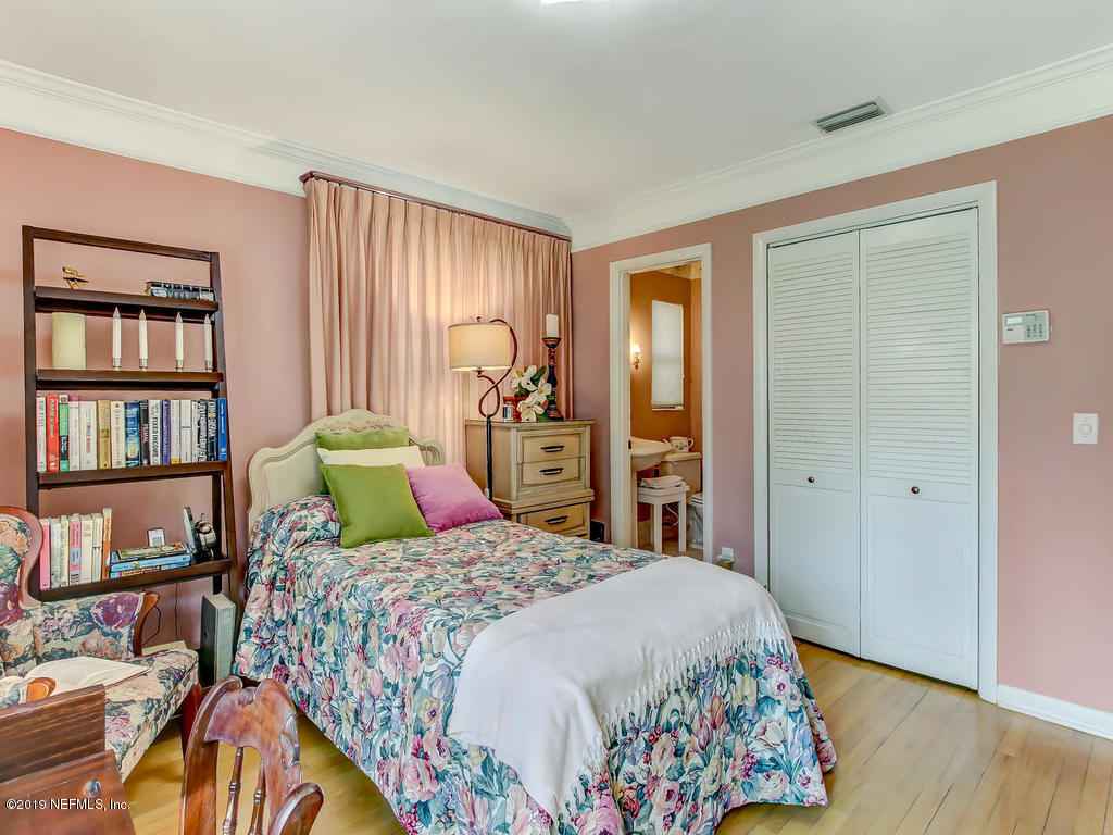 365 9th Street Atlantic Beach, FL 32233 - Photo 27 of 37 a bedroom with a bed a dresser and a book shelf