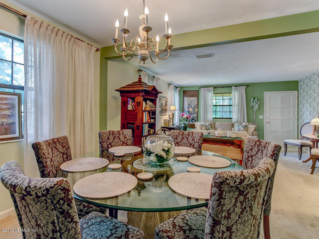 365 9th Street Atlantic Beach, FL 32233 - Photo 9 of 37 a view of a dining room with furniture and a chandelier