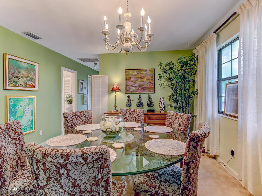 365 9th Street Atlantic Beach, FL 32233 - Photo 10 of 37 a view of a dining room with furniture a chandelier and large windows