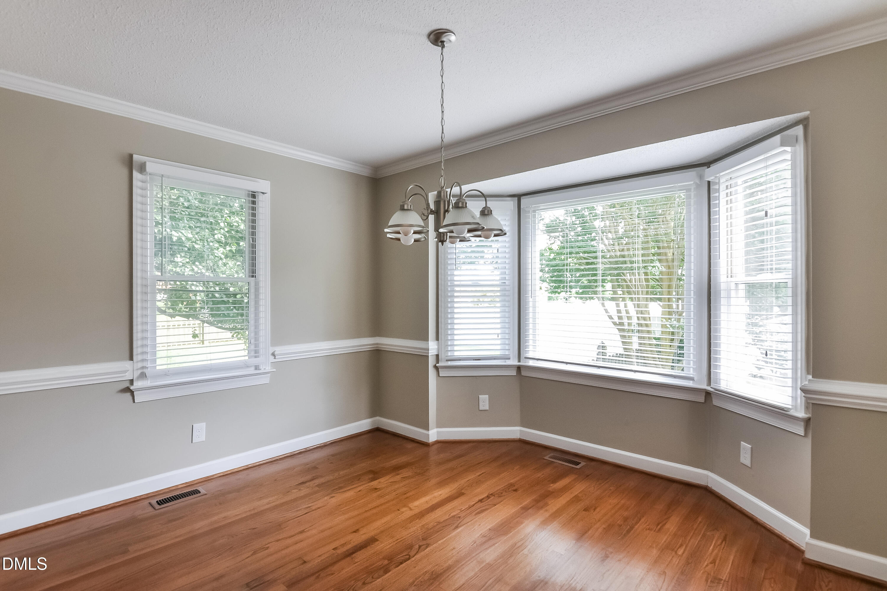 17 Brookwood Drive Smithfield, NC 27577 - Photo 4 of 17 a view of an empty room with wooden floor and a window