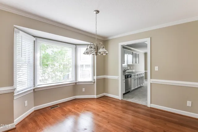 a view of a room with window and wooden floor
