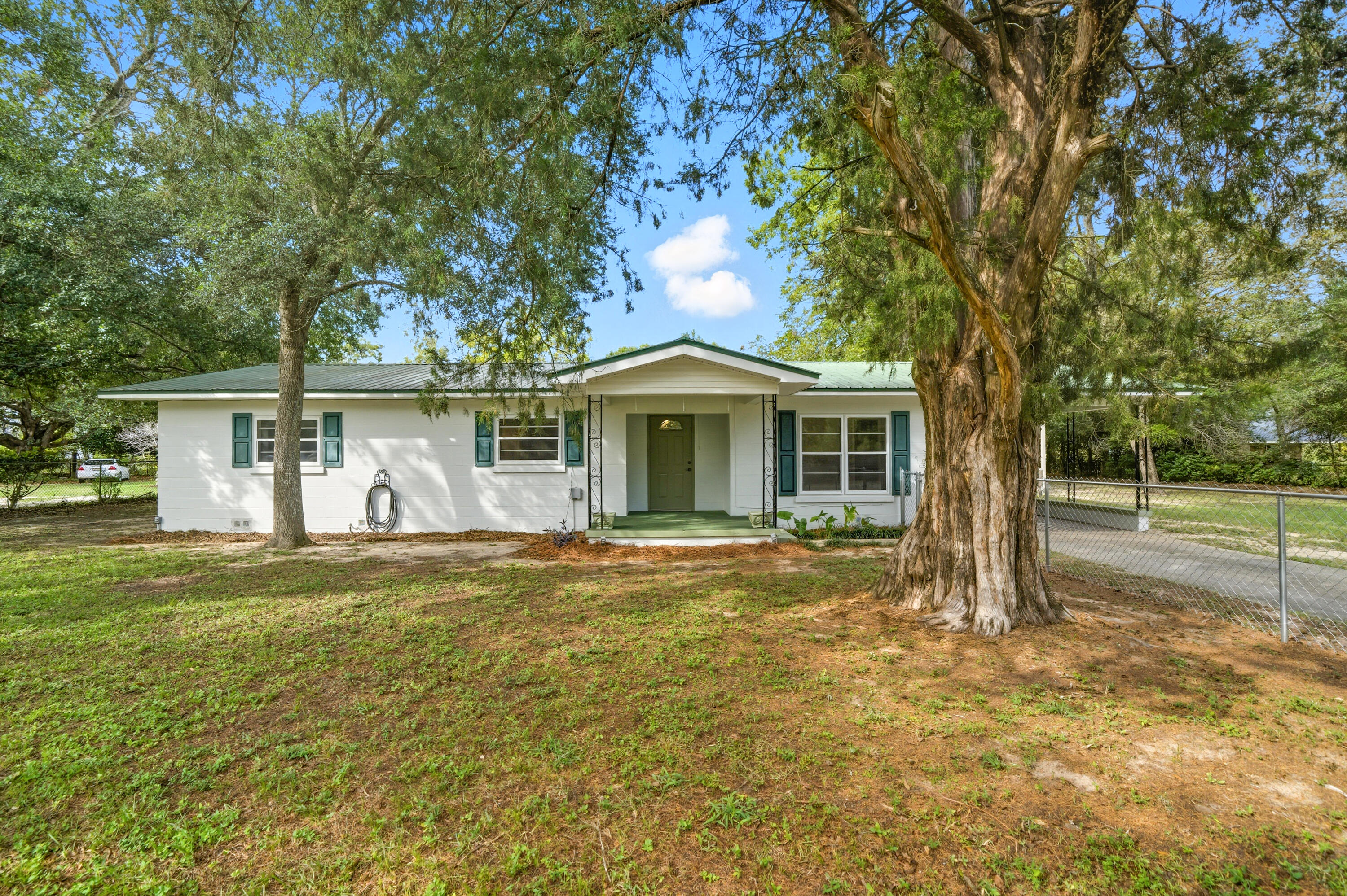 2128 3rd Avenue Crestview, FL 32539 - Photo 1 of 50 a front view of a house with a garden