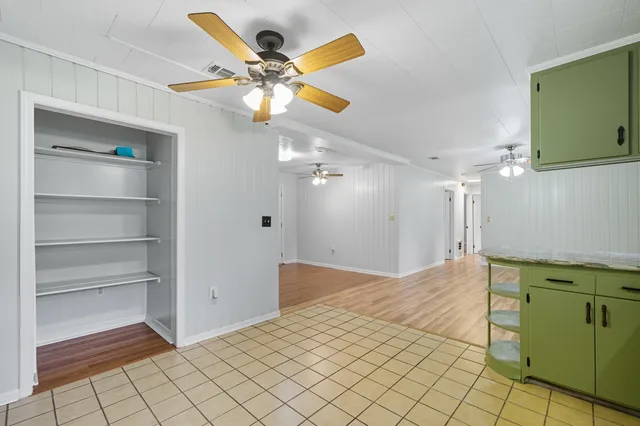 a kitchen with a stove cabinets and window